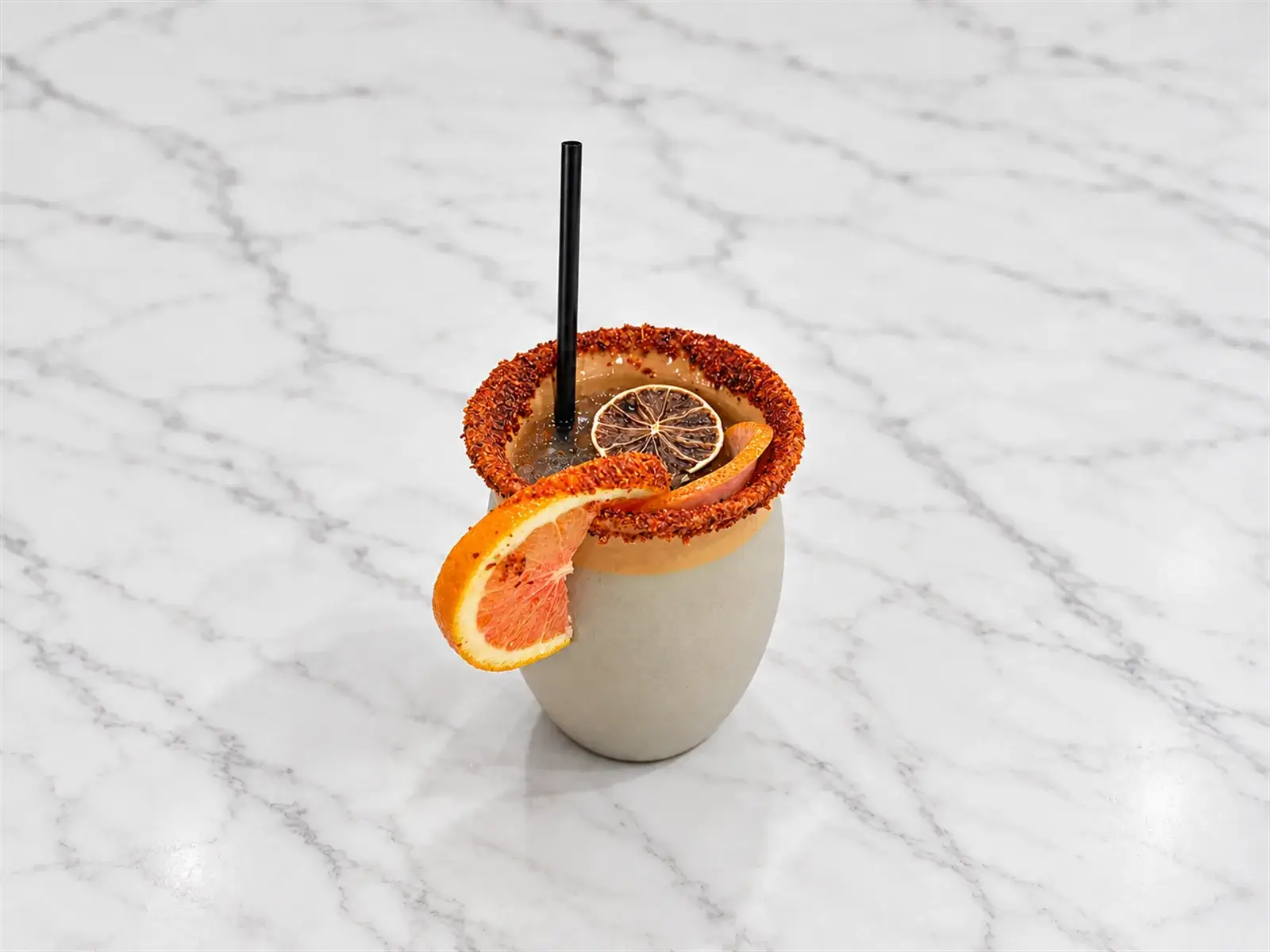A cantarito with grapefruit, orange, and lime