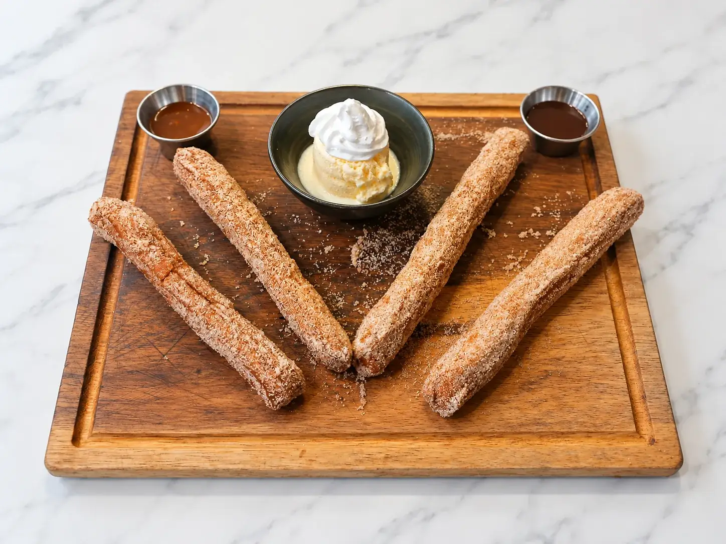Warm cinnamon sugar churros with dipping sauces