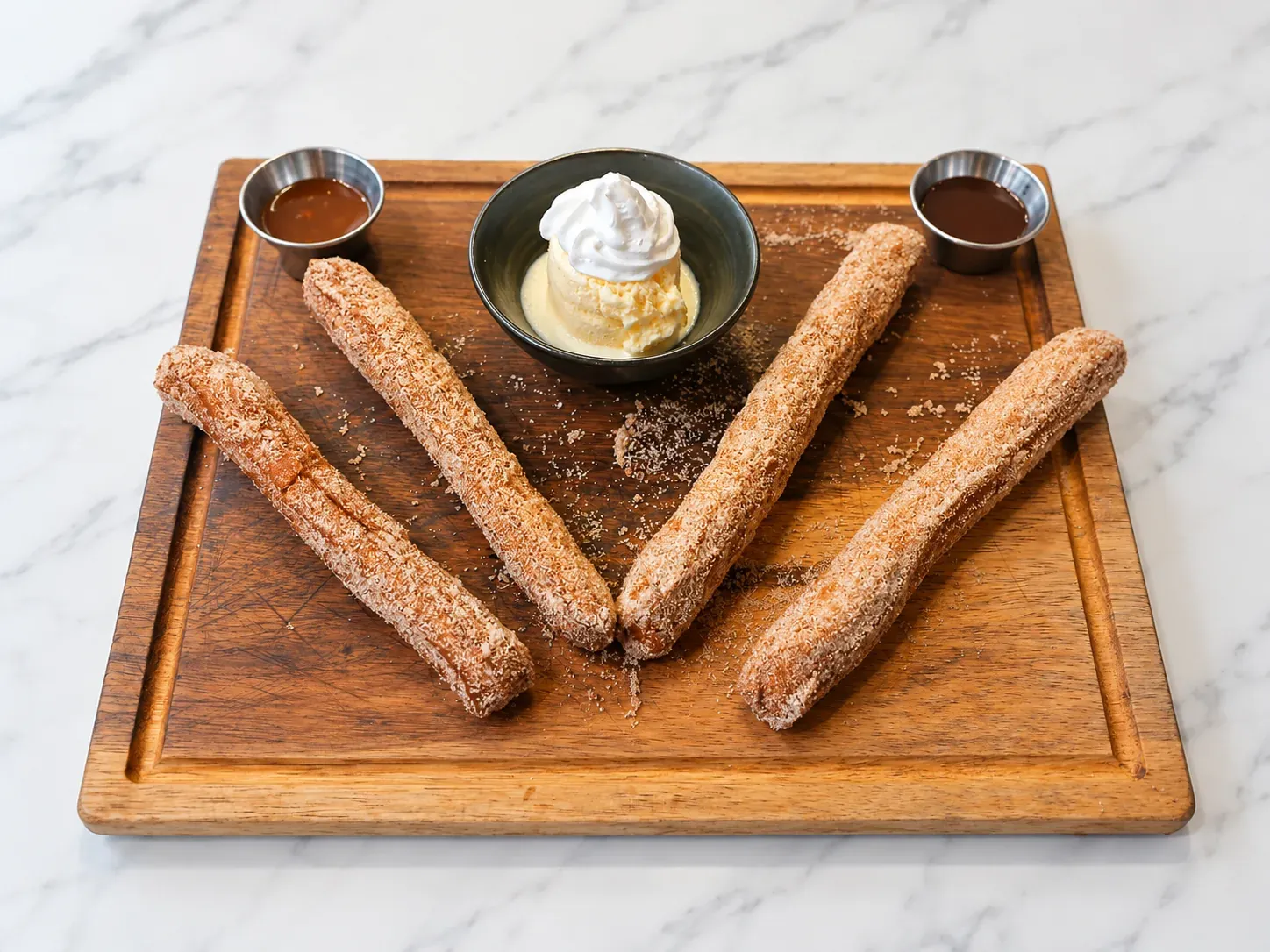 Cinnamon sugar churros with ice cream and dipping sauces