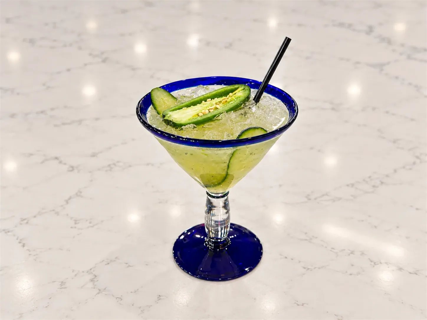 Cucumber jalapeño margarita garnished with cucumber and jalapeño slices