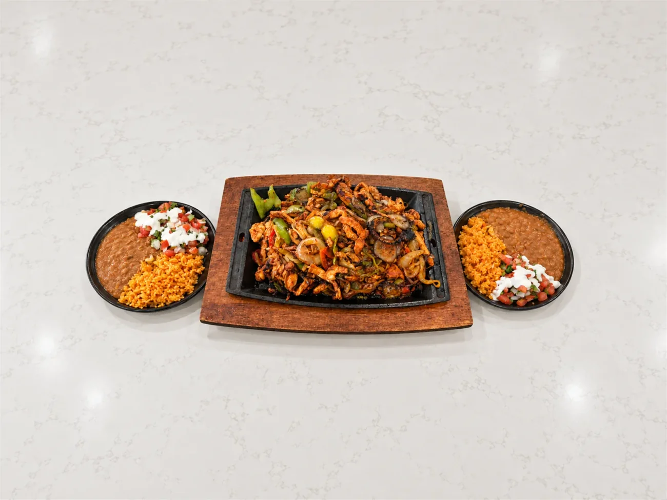 Fajitas for two served with rice, beans, and warm tortillas