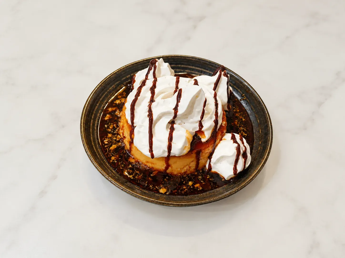 Flan topped with whipped cream and chocolate drizzle