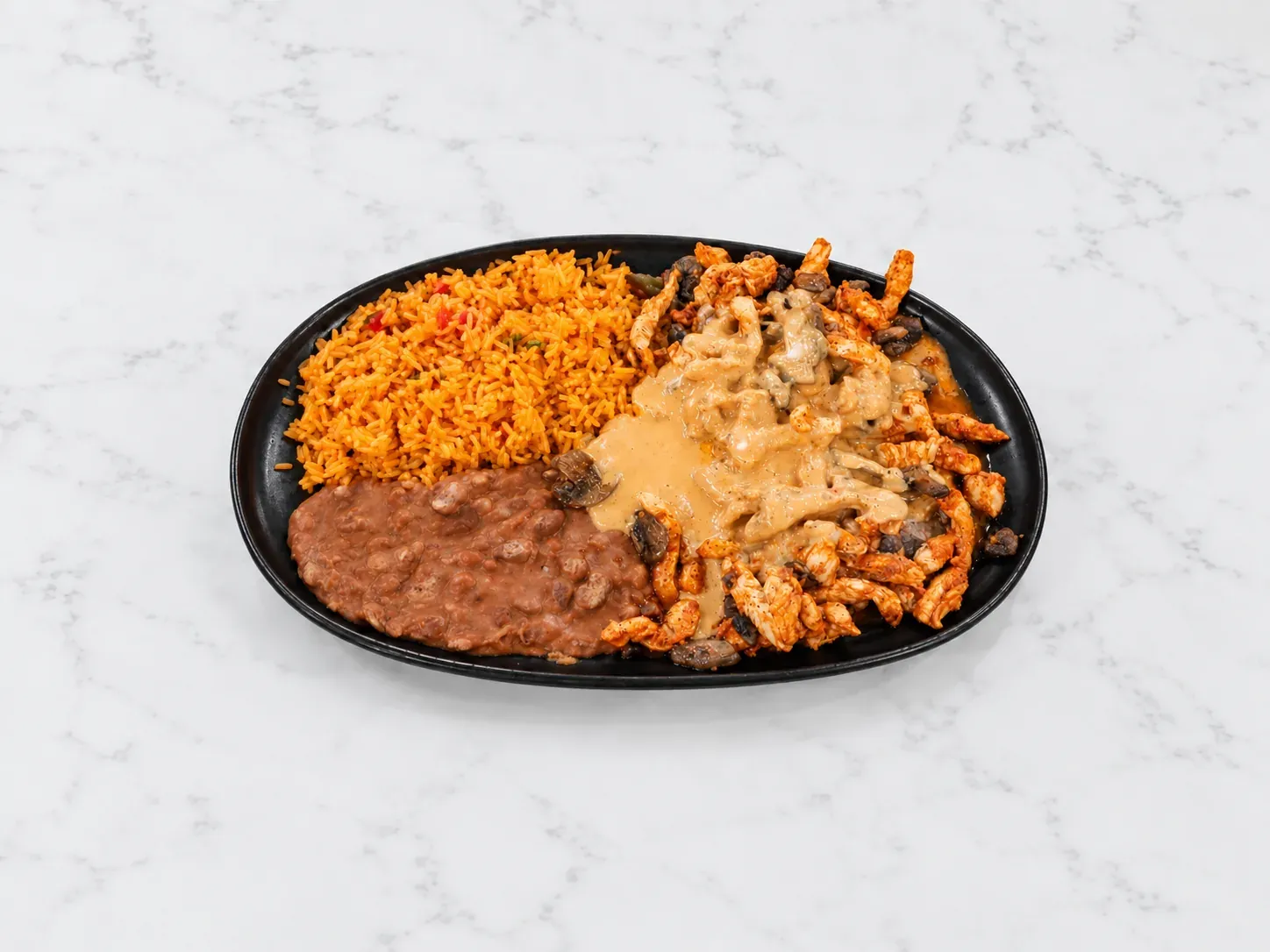 Pollo Chipotle with grilled chicken, chipotle cream, mushrooms, rice, and beans