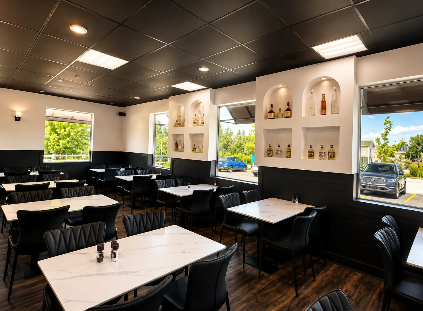 Aruma's bright dining room with marble tables and black chairs