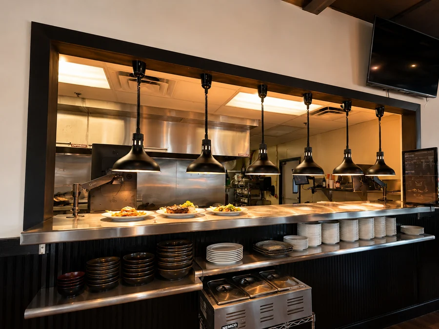 Aruma's open kitchen pass with plates ready for service