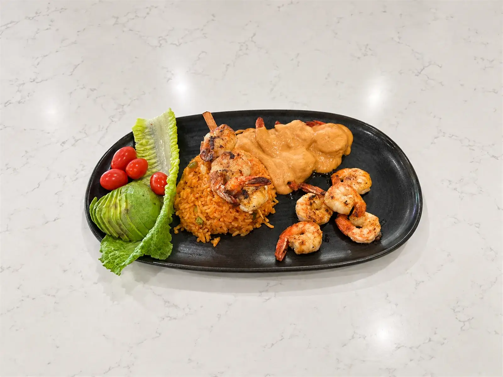 Trio shrimp prepared three ways with rice and avocado